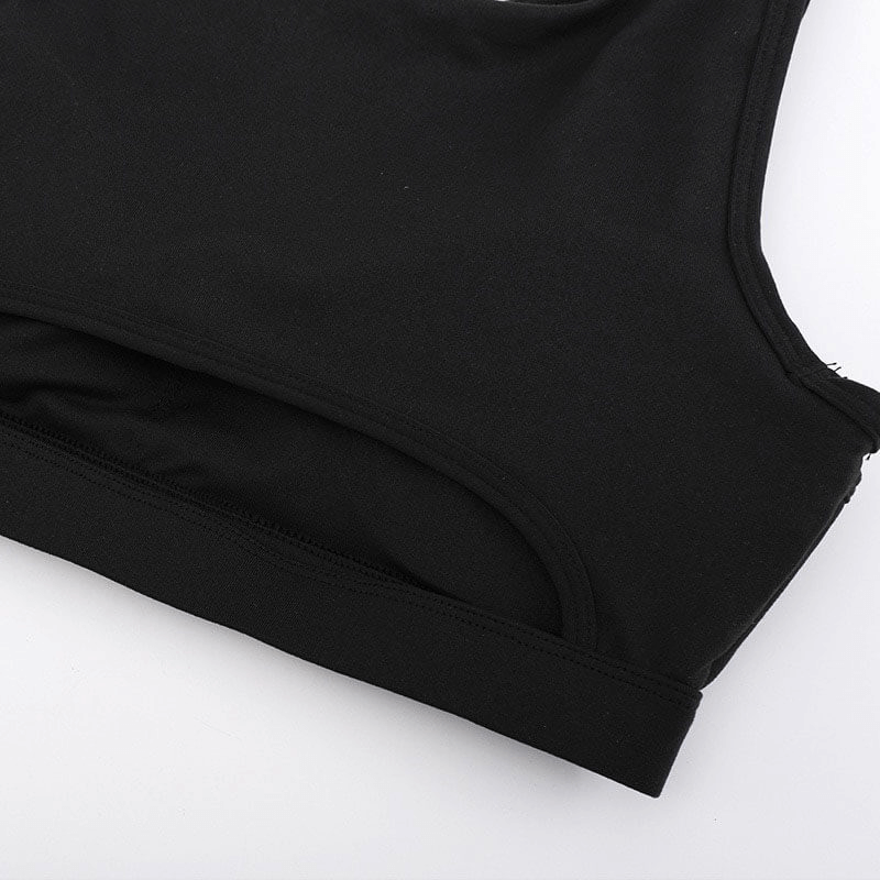 Close-up view of black women's athletic sports bra, featuring breathable and elastic fabric for yoga and running.